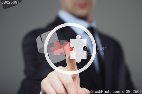 Image of businessman hand draws puzzles as partnership concept