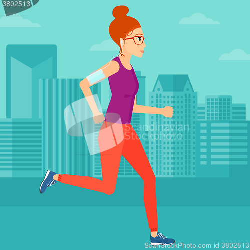 Image of Woman jogging with earphones and smartphone.