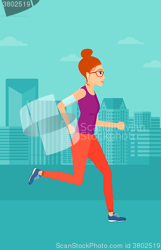 Image of Woman jogging with earphones and smartphone.