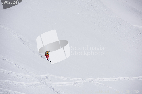 Image of freeride skier skiing in deep powder snow