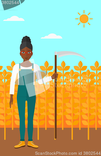 Image of Farmer on the field with scythe.