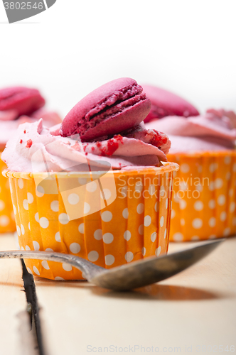 Image of pink berry cream cupcake with macaroon on top