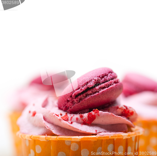 Image of pink berry cream cupcake with macaroon on top