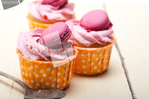 Image of pink berry cream cupcake with macaroon on top