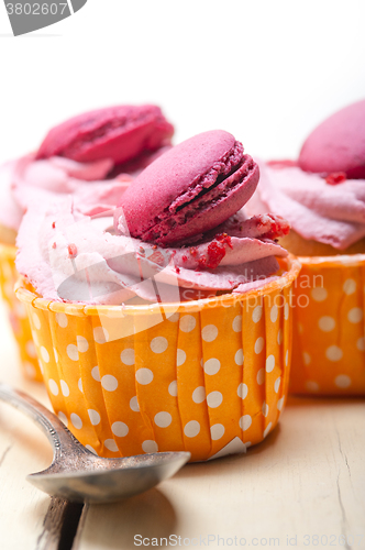 Image of pink berry cream cupcake with macaroon on top