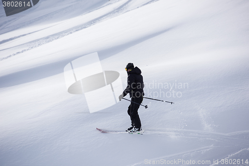 Image of freeride skier skiing in deep powder snow