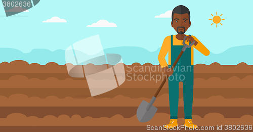 Image of Farmer on the field with shovel.