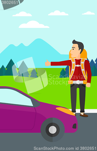 Image of Young man hitchhiking.