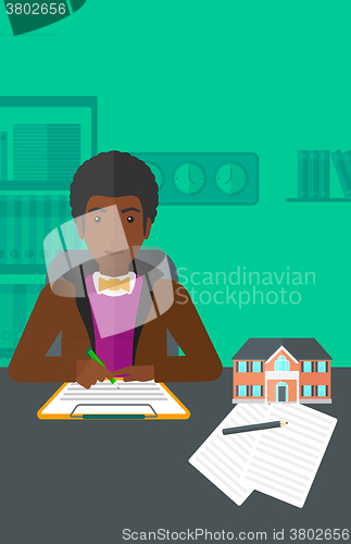 Image of Real estate agent signing contract.