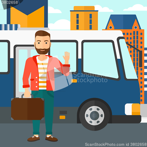 Image of Man standing near bus.