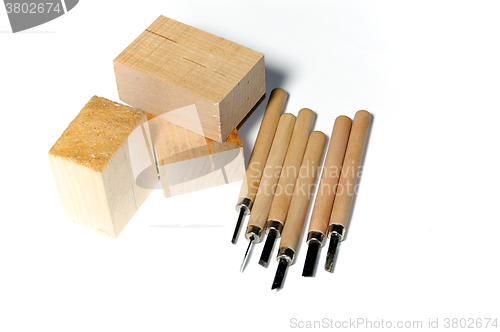 Image of wood carving tools with wood