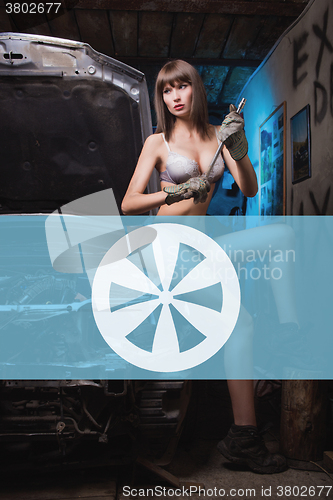 Image of Icon car repairs on the background of a woman mechanic