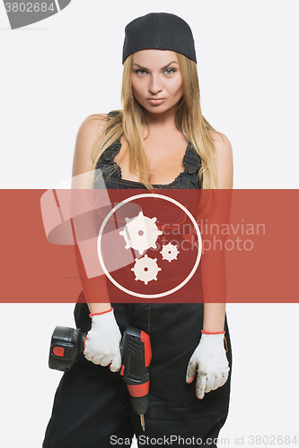 Image of sexy female holding a cordless screwdriver. Repair icon in the background woman.