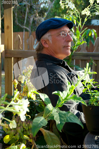 Image of man in garden looking pleased