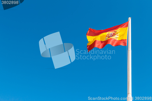 Image of Spanish flag in the blue sky