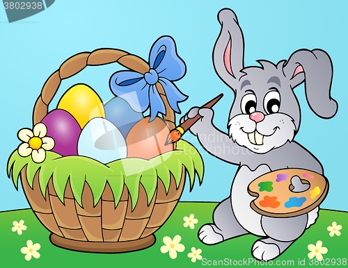 Image of Bunny painting eggs in basket