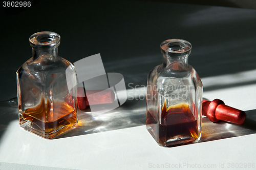 Image of two square eye dropper bottles
