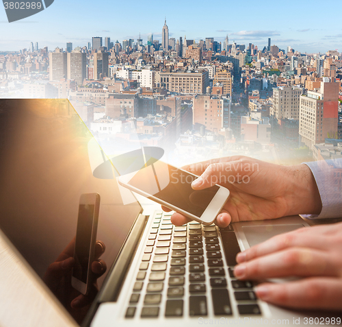 Image of The businessman with laptop and city