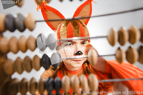 Image of Young woman in the image of red squirrel with abacus 