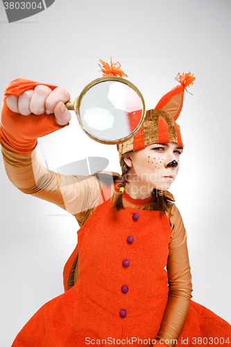 Image of Young woman in image of squirrel with magnifying glass