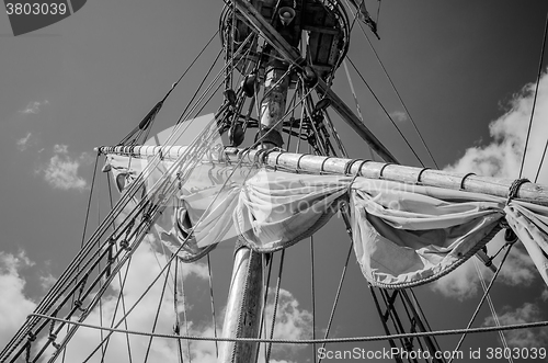 Image of Mast with sails of an old sailing vessel, black and white photo