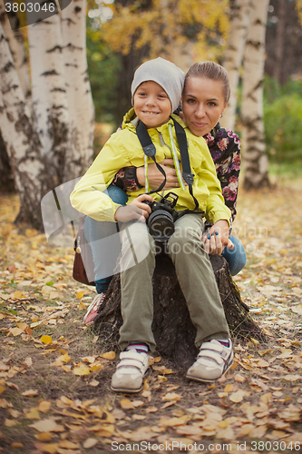 Image of Woman and her son with camera