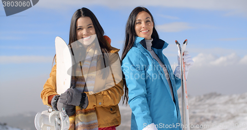 Image of Two gorgeous young women posing with snowboards