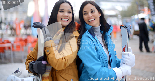 Image of Two gorgeous young brunette snowboarders