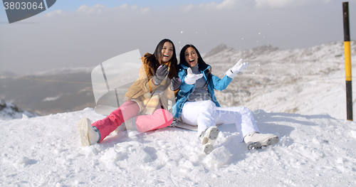 Image of Two young women frolicking in the snow