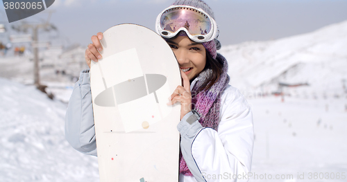 Image of Laughing young woman with her snowboard