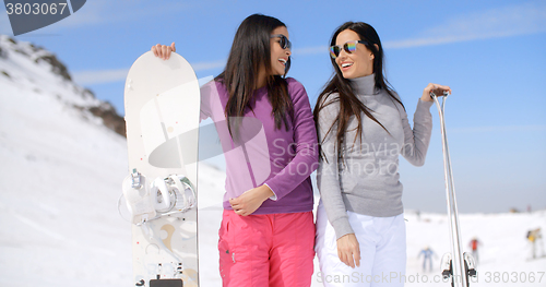 Image of Cute sisters with snowboards