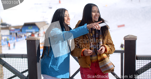 Image of Two young woman on a winter ski vacation