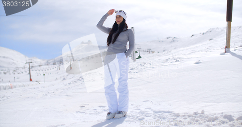 Image of Attractive young woman standing in winter snow