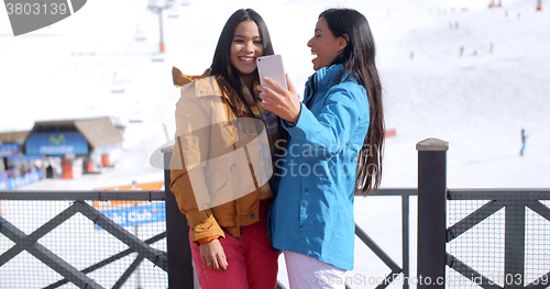 Image of Two young women laughing at their selfie