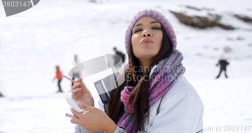 Image of Young woman blowing a kiss at the camera