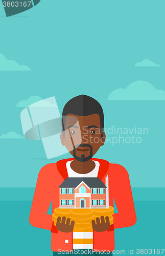 Image of Man holding house model.