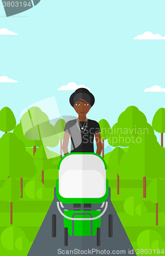 Image of Woman pushing pram.