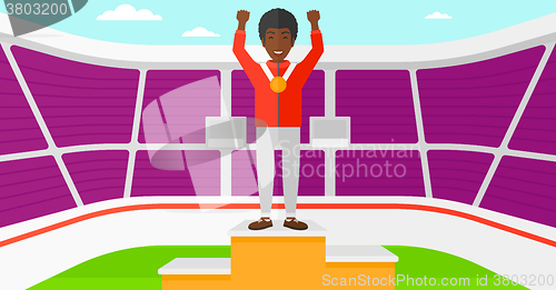 Image of Athlete with medal and hands raised.