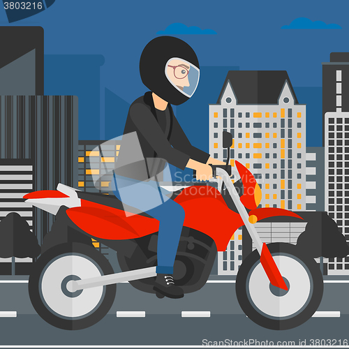 Image of Man riding motorcycle.