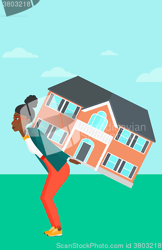 Image of Woman carrying house.