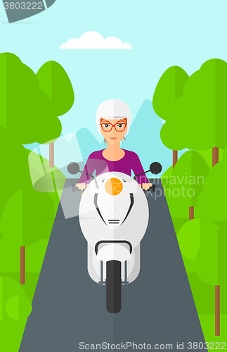 Image of Woman riding scooter.