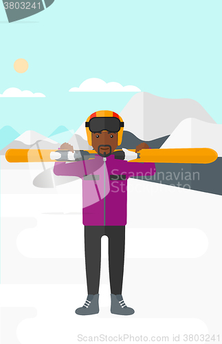 Image of Man holding skis.