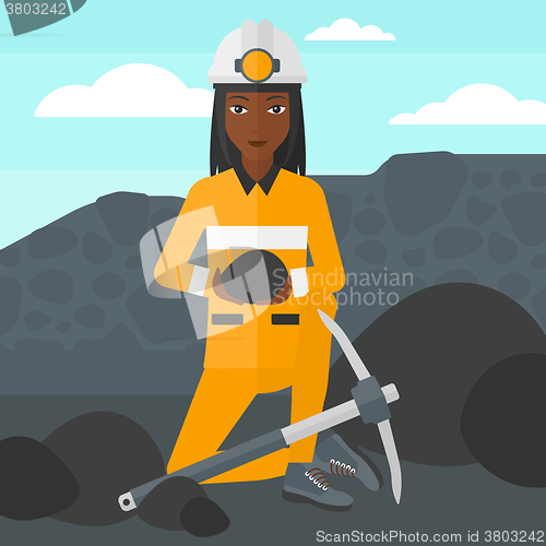 Image of Miner holding coal in hands.