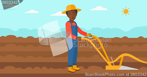 Image of Farmer on the field with plough.