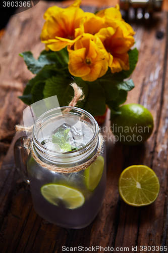 Image of fresh mojito on a rustic table.