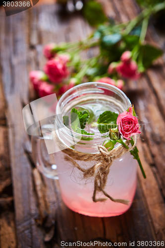 Image of fresh mojito on a rustic table.