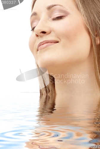 Image of bright picture of smiling woman in water