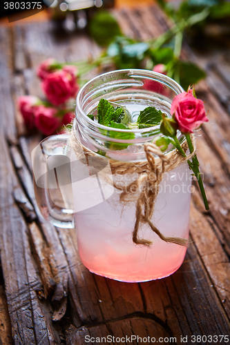 Image of fresh mojito on a rustic table.