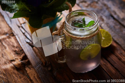 Image of fresh mojito on a rustic table.