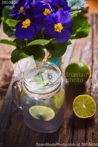 Image of fresh mojito on a rustic table.